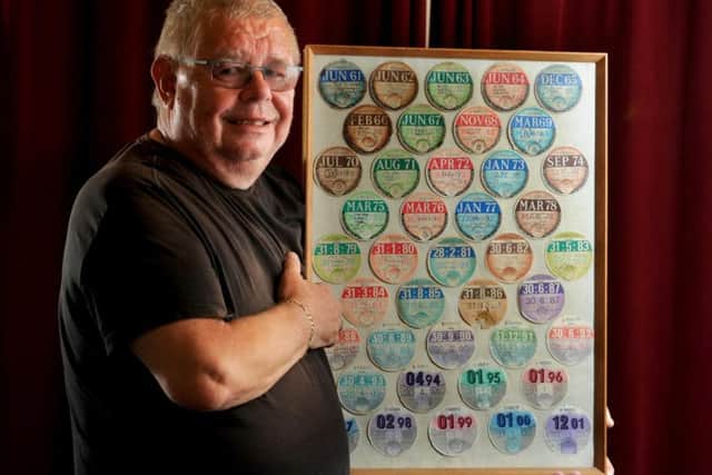 Robert Watkinson shows off his tax disc collection