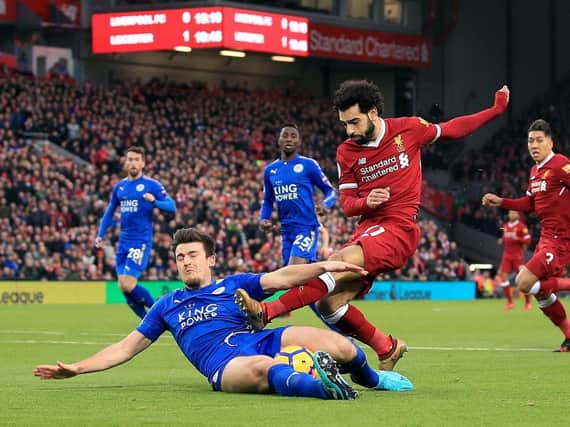 Harry Maguire slides on on Liverpool's Mo Salah at Anfield last season.