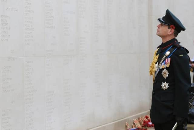 The Earl of Wessex views names of fallen armed forces personnel during Armistice Day commemorations at the National Memorial Arboretum in Alrewas, Staffordshire in 2014