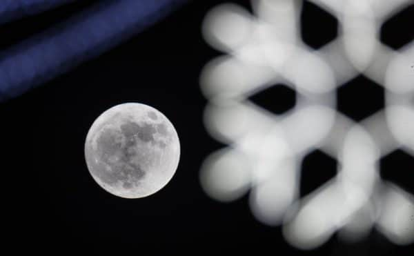 A 'Wolf Moon' behind festive seasonal lights on display in the High Street in Wells in 2018 (Photo: Matt Cardy/Getty Images)